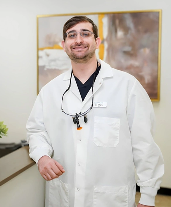 Dr. Mark Berenshteyn, dentist at Fitchburg dental practice, wearing white coat and stethoscope.