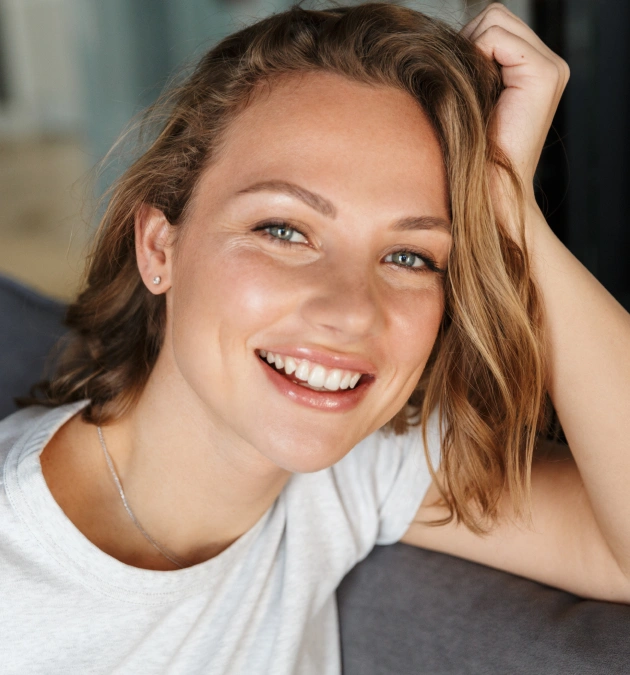 Happy woman with bright smile showcasing cosmetic dentistry results in Fitchburg, MA.