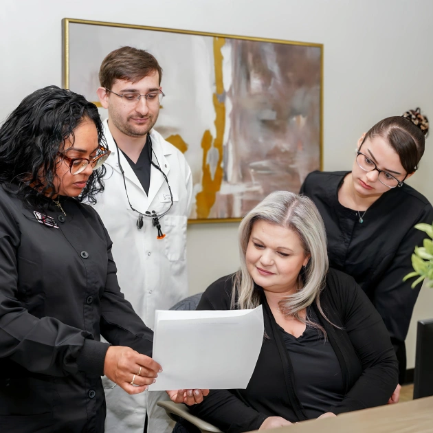 Dental team reviewing membership plans with patient at Fitchburg practice.