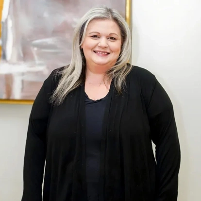 Stephanie Bouchard, dental practice team member, smiling in professional portrait.