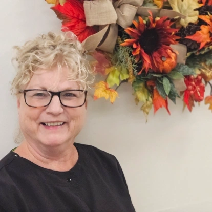 Susan Chaplin, dental team member at Fitchburg practice, smiling warmly.
