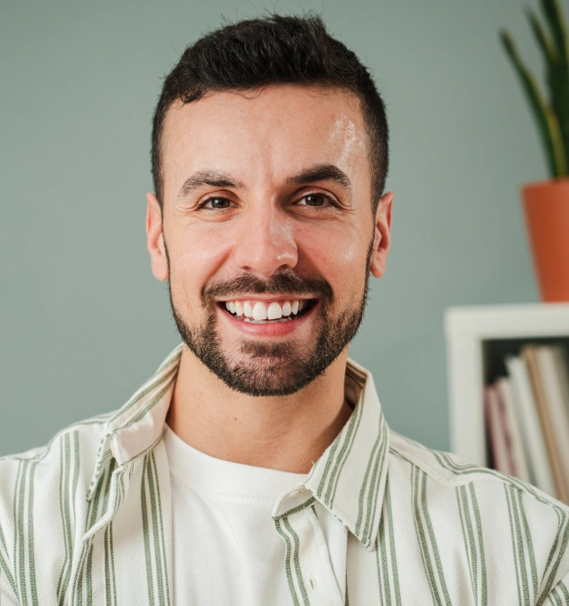 Smiling man with whitened teeth in dental office setting at Fitchburg practice.